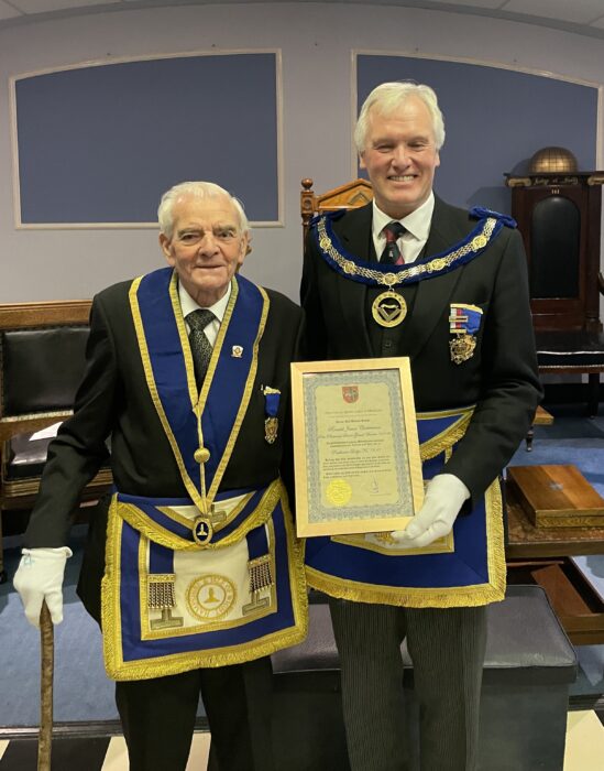 W. Bro Ron Chesterman PPrSGW receiving his 70 years certificate of service from the APGM W.Bro Bob Rough PSGD at Parthenon Lodge No7310 meeting in April 2024